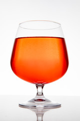 glass goblet with light red wine