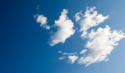 Fototapeta na wymiar Blue sky with white fluffy translucent clouds