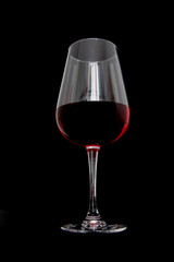 Glass of red wine on black background