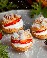 french choux pastry with white cream and strawberries