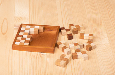 Wooden polymino puzzle on a wooden table.
