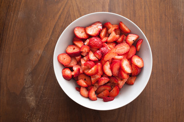 high angle view of sliced straberries in a white plate