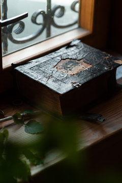 Old rusty bible on the window sill