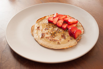 Strawberry pancake on a white plate