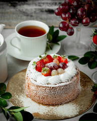 fruit cake topped with strawberry white and red grape