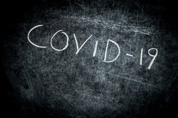 Obraz premium Coronavirus, Covid-19 drawn text with chalk on blackboard