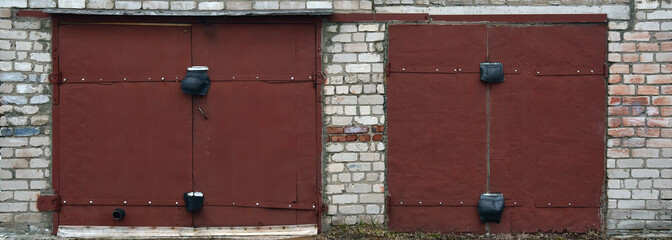 Red metal double door, old garage door, paint peeling off
