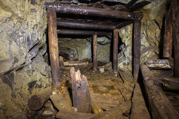 Fototapeta premium Underground abandoned platinum ore mine tunnel collapsed wooden timbering