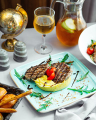 grilled beef patties served with mashed potatoes