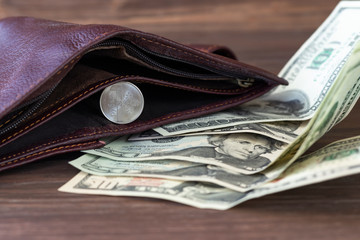 Wooden background in a dark style. On it are banknotes one hundred dollars and one ruble. Exchange...
