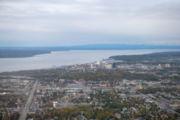 Fototapeta na wymiar Aerial view of downtown Anchorage and Port on Knik Arm from a taking off airplane in Anchorage, Alaska, AK, USA.