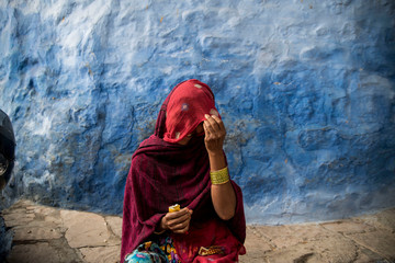 woman wears a red veil in jodhpur india
