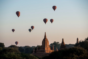 hot air balloons rise over the ancient temples of bagan at sunrise in myanmar