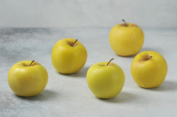 group of apples on a gray background - yellow apples