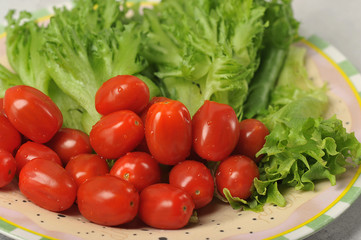 cherry tomatoes with lettuce leaves on a plate