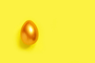 .Easter flat lay background of colorful eggs on a yellow background, Easter pattern top view with copy space.