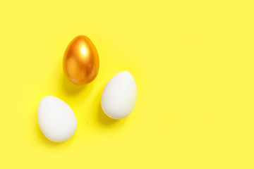 .Easter flat lay background of colorful eggs on a yellow background, Easter pattern top view with copy space.