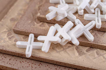 Industrial tiles and plastic crosses for tiling. Accessories for construction workers.