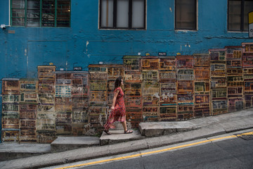 female traveler walking in front of graffiti wall in hong kong