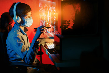 Young boy studying at home with online courses during the coronavirus quarantine. Distance education concept.