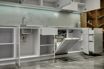 Multifunctional modern kitchen. Opened cabinets and drawers
