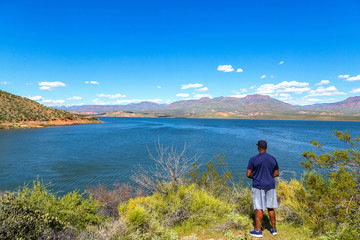 African American Man Looking at Roosevelt Lake in the Arizona Desert
