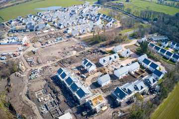 Suburban house development aerial view with countryside views uk
