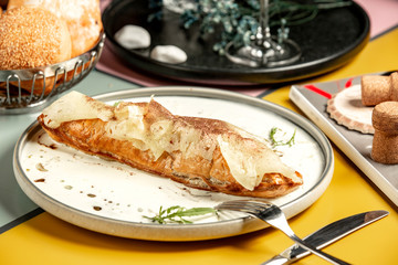 long pie topped with pineapple slices and cinnamon powder