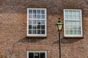stylish background of texture brick wall windows and lamp on the typical house in netherlands small town