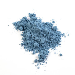 Close-up of blue matcha tea powder isolated on a white background