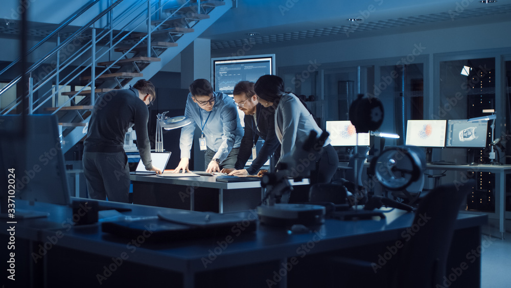 Aufkleber Diverse Team of Electronics Development Engineers Standing at the Desk Working with Documents, Solving Project Problems Late at Night. Specialists Working on Ultra Modern Industrial Design.