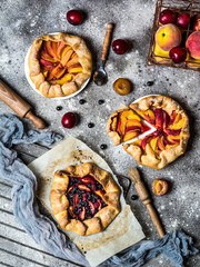 Summer galette with berries, raspberry, blueberry, blackberry, apple and crusty sugar vegetarian dough. Vegan food. Healthy food. Peach pie. Tart. Summer food, summer pie on parchment paper.