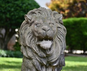 Fototapeta na wymiar Front yard landscape featuring a lion statue