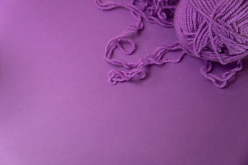 Background with knitting tools and accesories, colorful purple skein yarn, hobby concept, copyspace