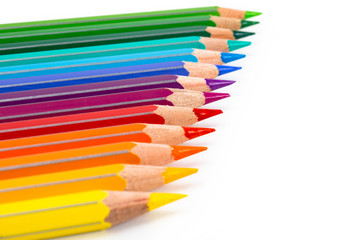 Color pencils in a row isolated on white. Macro still-file picture made in studio with softbox.