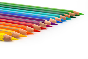 Colored pencils in a row isolated on white. Macro still-file picture made in studio with softbox.