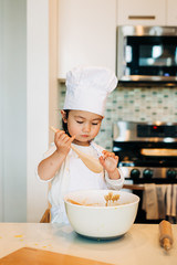 Toddler Girl Baking Cookies Wearing Toque