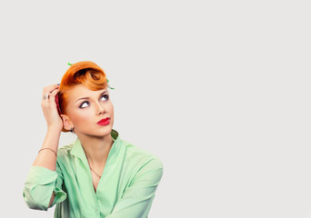 headshot young pin up woman scratching head, thinking daydreaming