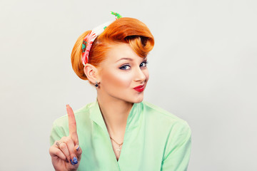 woman gesturing a no sign. serious pinup retro style girl raising finger up saying oh no