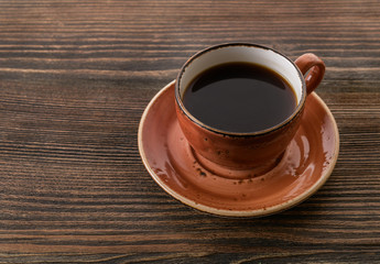 cup of coffee on a wooden background