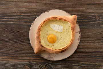 Adjara khachapuri on a wooden background