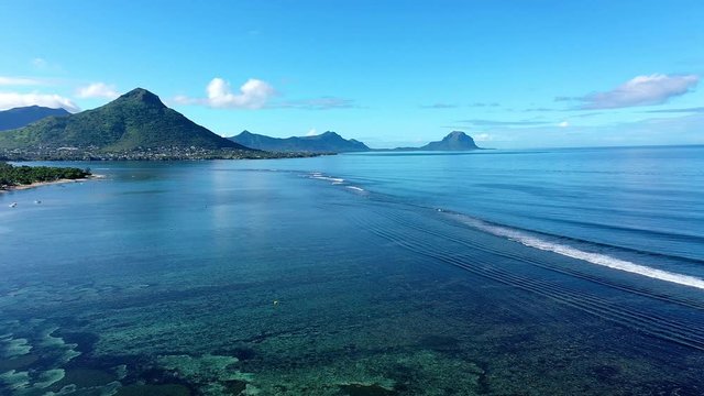 The beach at Flic en Flac with luxury hotels and palm trees, behind the mountain Tourelle du Tamarin, Mauritius, Africa