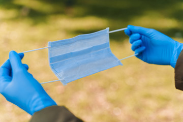 Epidemiological methods of prevention for protection from sars cov 2. Medical mask in hands. Blue...
