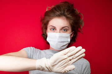 Stop the virus and epidemic diseases. Healthy woman in blue medical protective mask showing gesture...