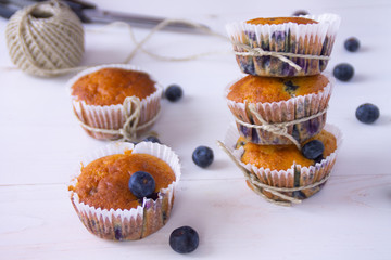 Blueberry muffins on a white wooden background