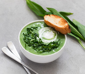 Soup-puree ramson with croutons in a white bowl on a light background