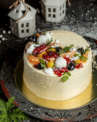 round cake decorated with fruits and coconut sprinkles