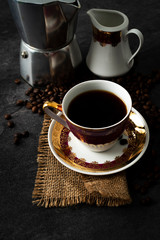 Cup of coffee, moka pot and coffee beans