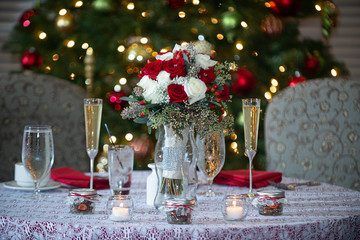 Red and White roses floral bouquet table centerpiece with colorful bokeh background
