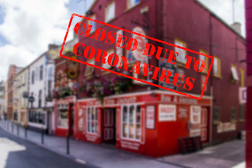Defocused view of exterior or of traditional pub, empty and closed due to coronavirus